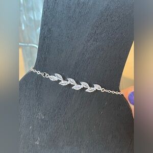 Silver tone bracelet with crystal leaves